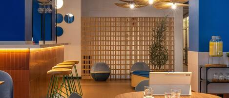 A modern conference room with a wooden table, chairs, and a decorative wall.