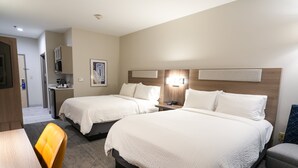 A hotel room with two beds, a desk, a chair, a small kitchenette, and a painting on the wall. - Holiday Inn Express & Suites Dallas Southwest-Cedar Hill by IHG (Cedar Hill)