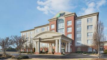 A Holiday Inn Express hotel with a central entrance, multiple floors, and a parking lot.