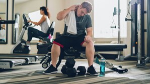 A gym with exercise equipment, a bench, dumbbells, and a water bottle on the floor. - Candlewood Suites San Antonio Downtown by IHG (San Antonio)