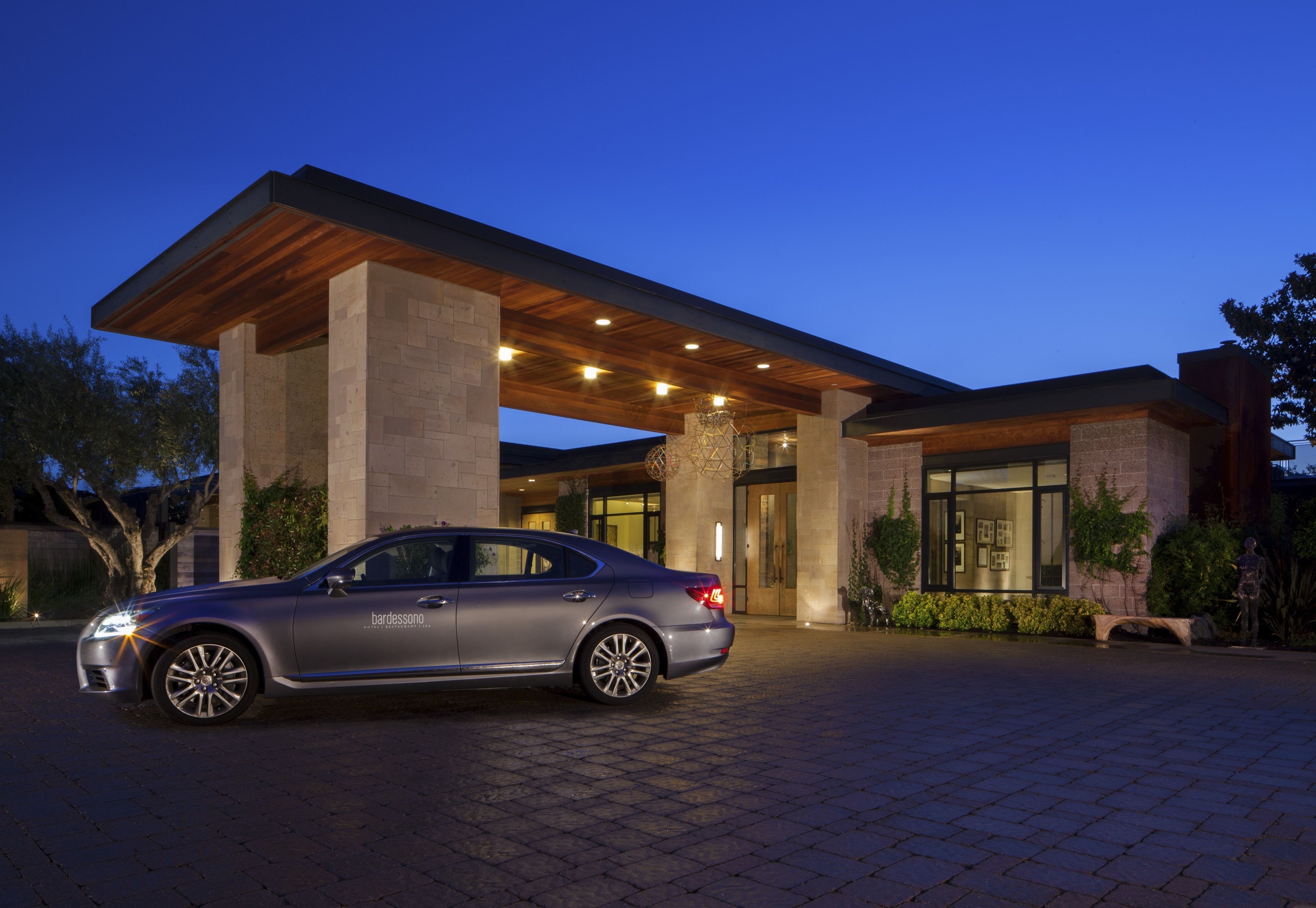 A modern building with a car parked in front.