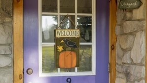 A purple door with a welcome sign, a number 9, and a sign indicating 'Vineyard'. - Savannah House Wine Country Inn & Cottages (Himrod)