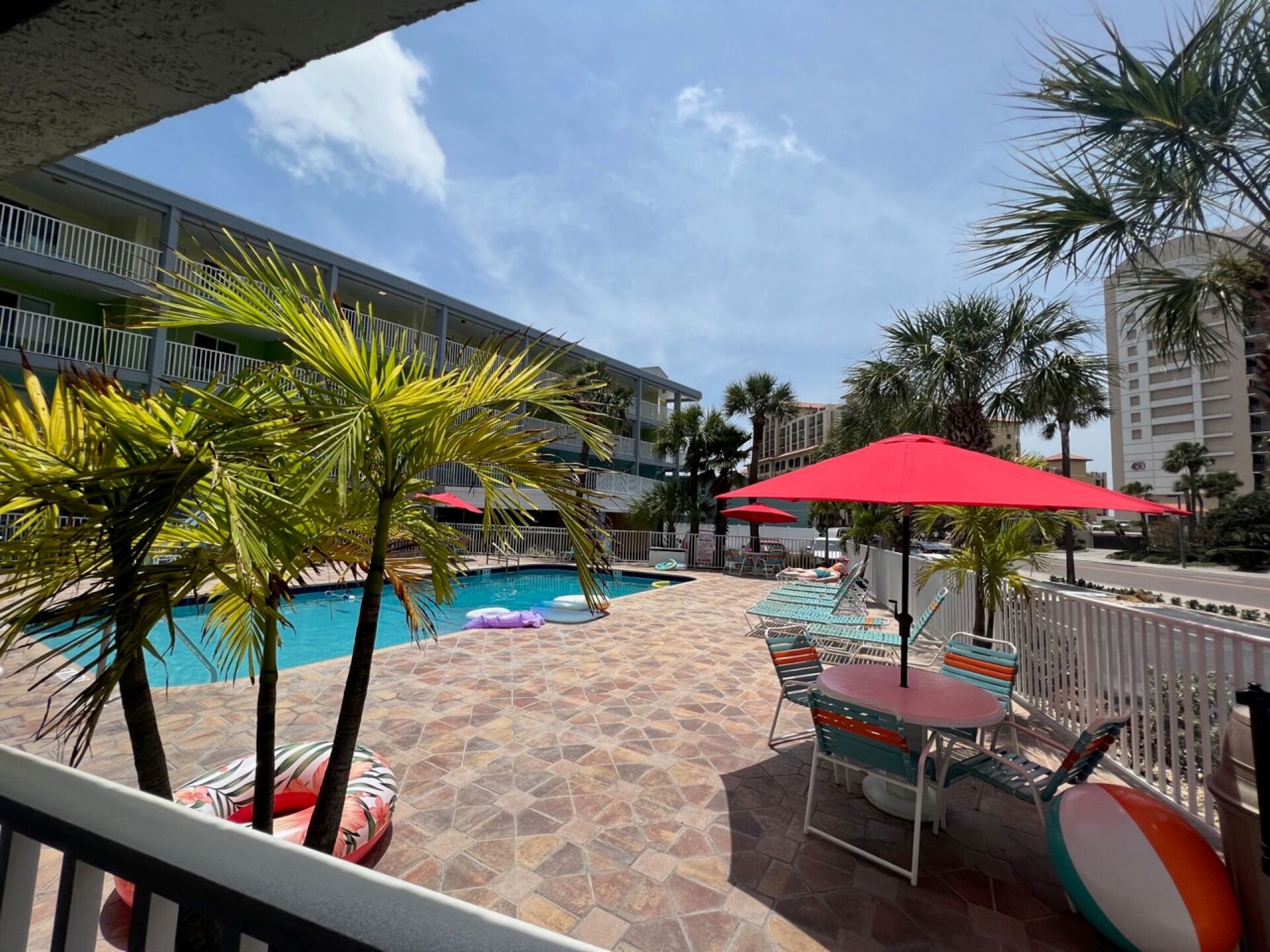 outdoor pool, a heated pool, open 8 am to 10 pm, pool umbrellas