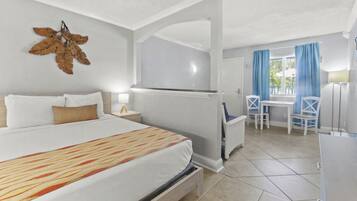 A hotel room with a bed, a desk, and a chair.