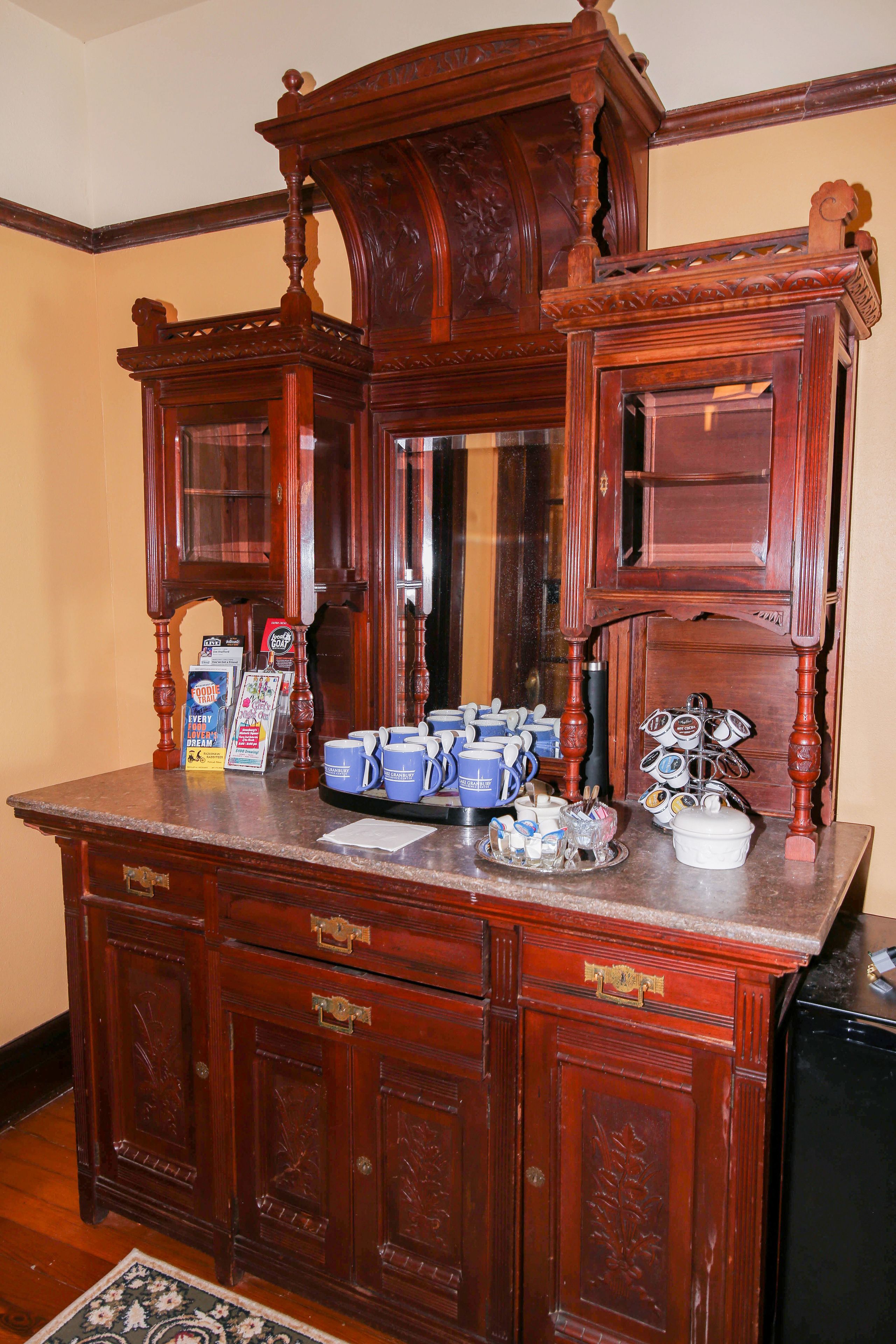 A wooden dresser with drawers and a mirror.