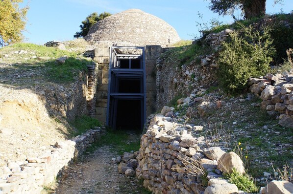 A stone structure with a large dome and a doorway leading into a building. - Irida Resort (Trifylia)