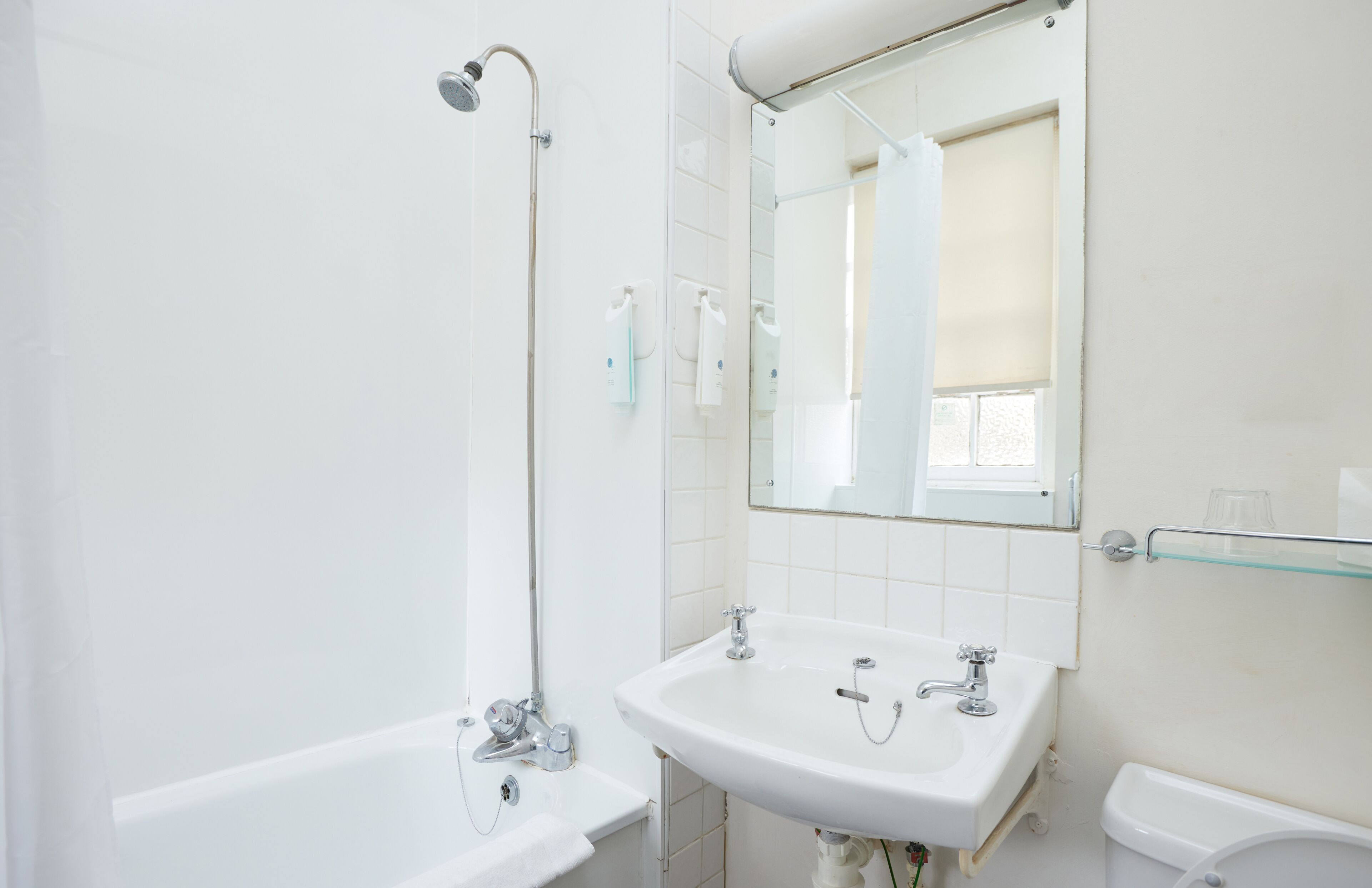 A bathroom with a bathtub, a sink, and a shower.