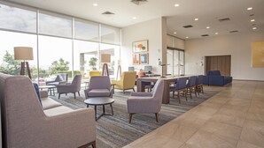 A spacious lobby with comfortable seating, large windows, and a modern design. - Holiday Inn Express Guadalajara Iteso by IHG (Tlaquepaque)