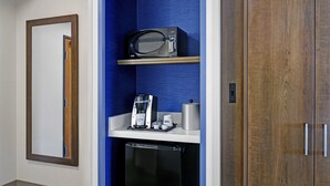 A compact kitchenette with a microwave, coffee maker, and a small refrigerator. - Holiday Inn Express Hotel & Suites NEWPORT by IHG (Newport)