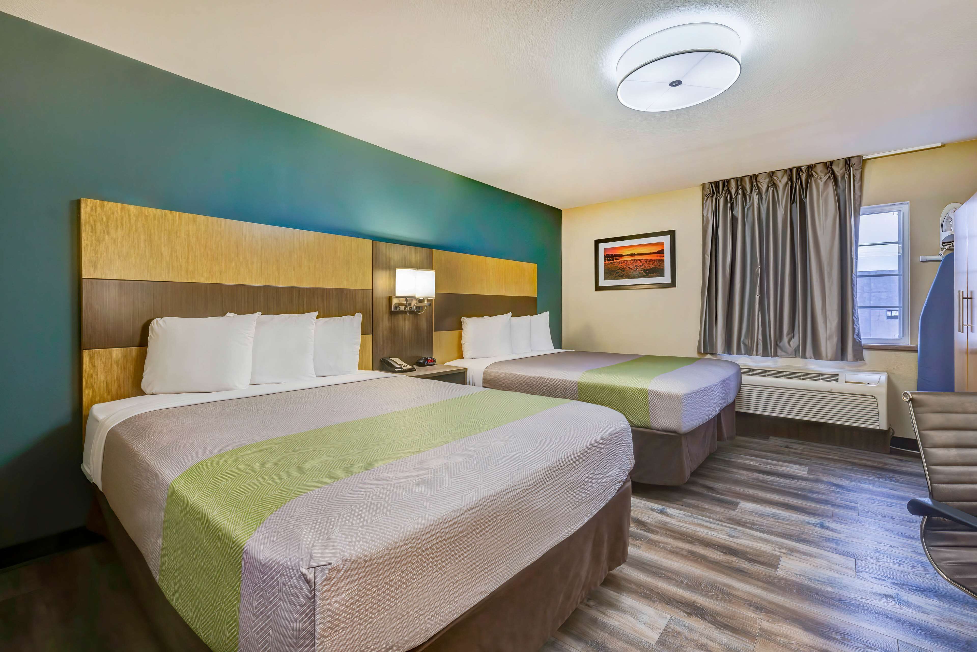 Desk, laptop workspace, blackout drapes, iron/ironing board