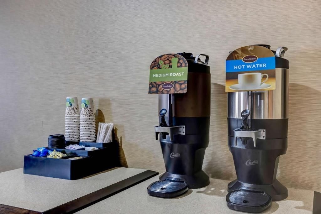 A coffee machine with a medium roast label and a hot water dispenser.
