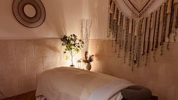 Relax in this serene bedroom with a large bed, potted plant, and stylish mirror.