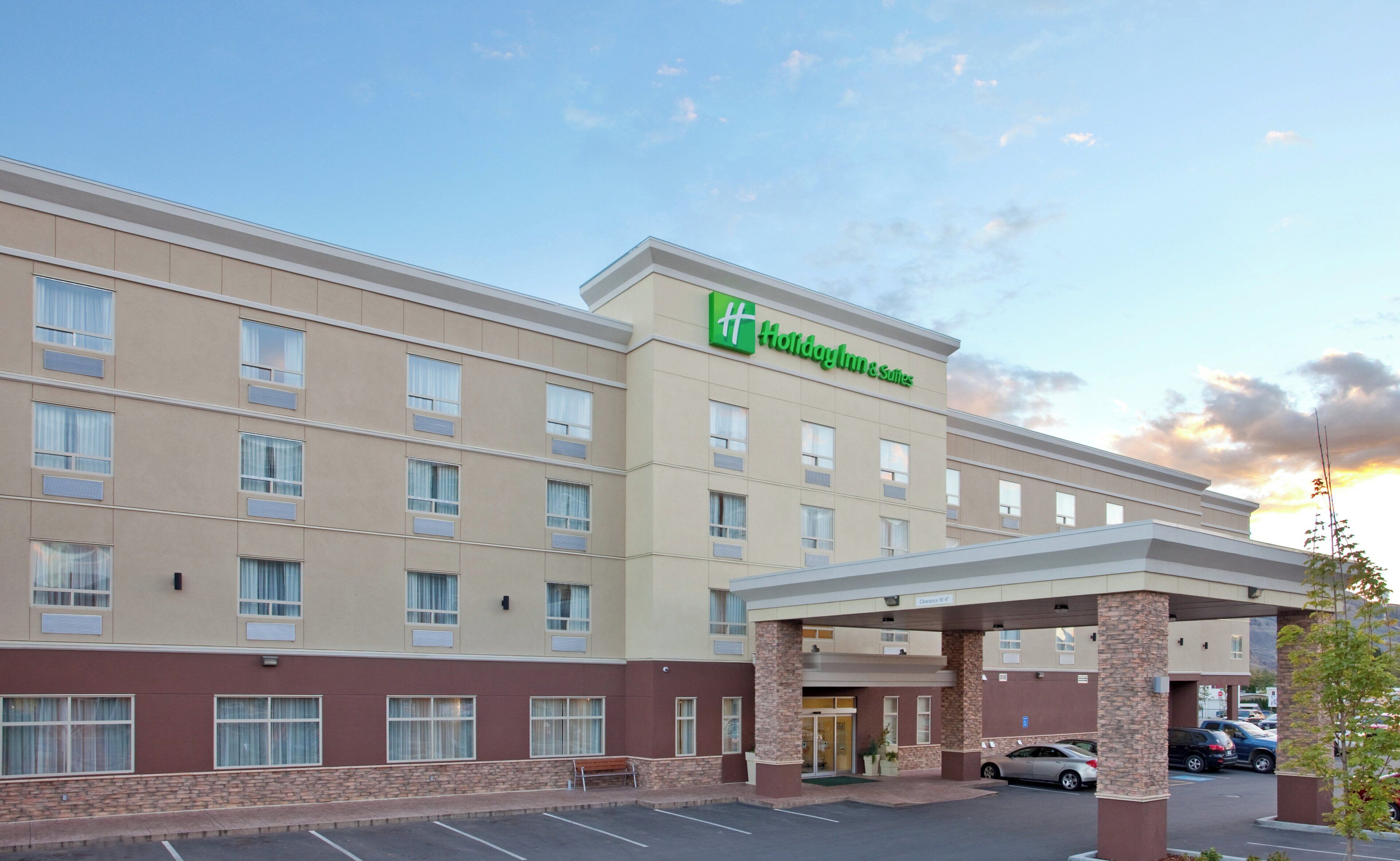 A Holiday Inn Express hotel with a covered entrance, multiple floors, and a parking lot.