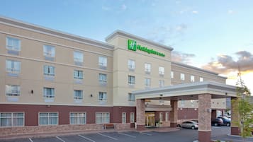 A Holiday Inn Express hotel with a covered entrance, multiple floors, and a parking lot.