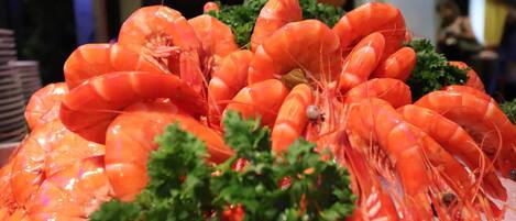 A display of cooked shrimp arranged in a pyramid shape, garnished with parsley.