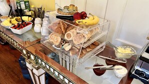 A buffet table with various food items and condiments. - Creole Gardens Guesthouse and Inn (New Orleans)