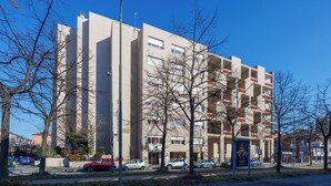 A multi-story building with a modern architectural style, featuring a central entrance and multiple balconies. - Residence Hotel Torino Uno (Turin)