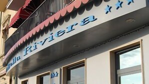 A hotel with a balcony, potted plants, and a sign that reads "Bella Riviera HOTEL". - Hotel Bella Riviera (Viareggio)