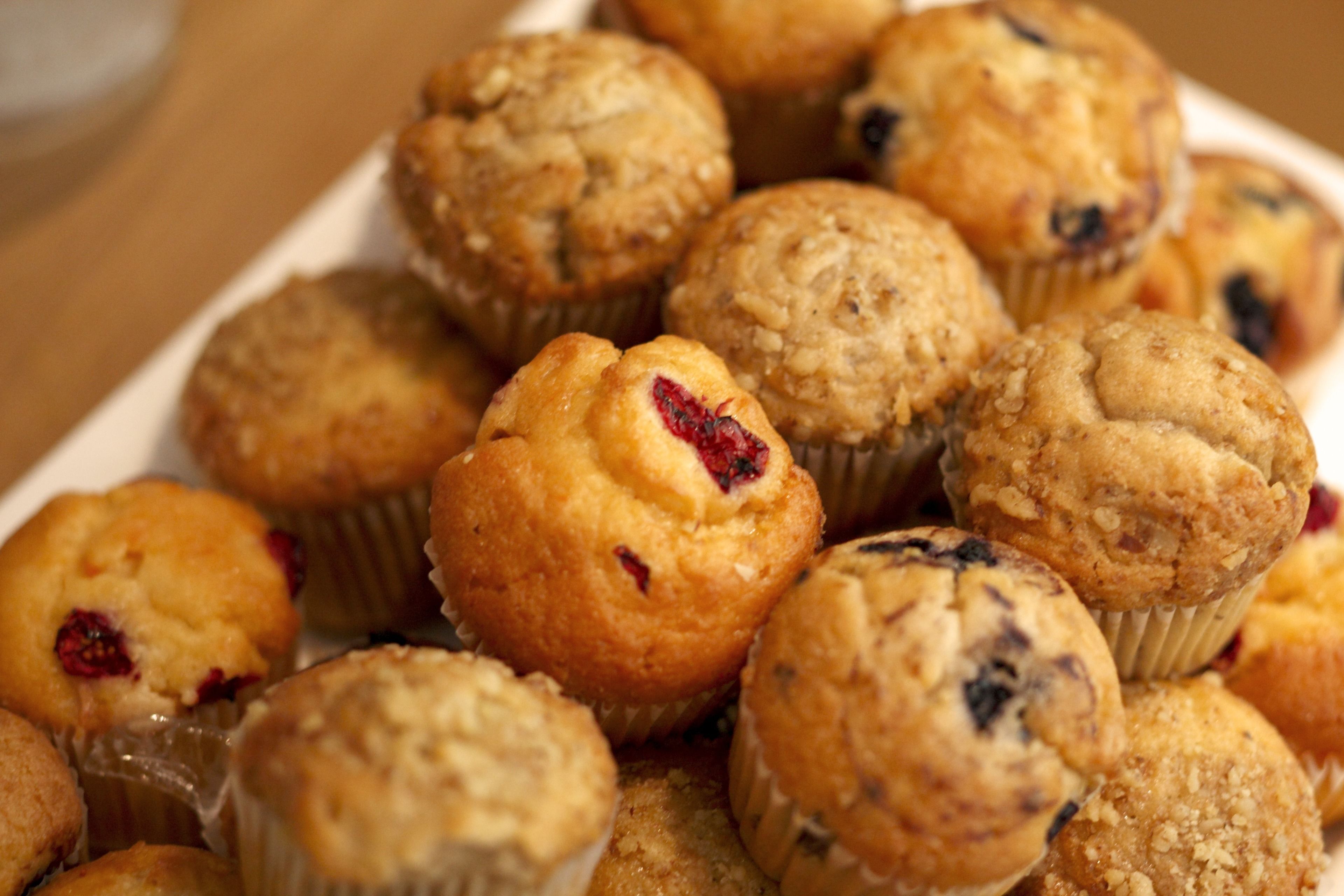 A tray of muffins with visible fruit pieces.
