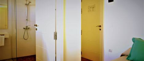 A bathroom with a shower, a toilet, and a sink.