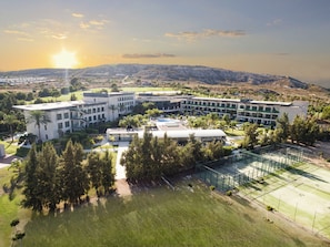 A modern hotel with multiple buildings, a swimming pool, and a tennis court. - La Finca Resort (Algorfa)