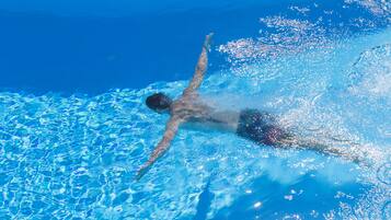 A person swimming in a pool.
