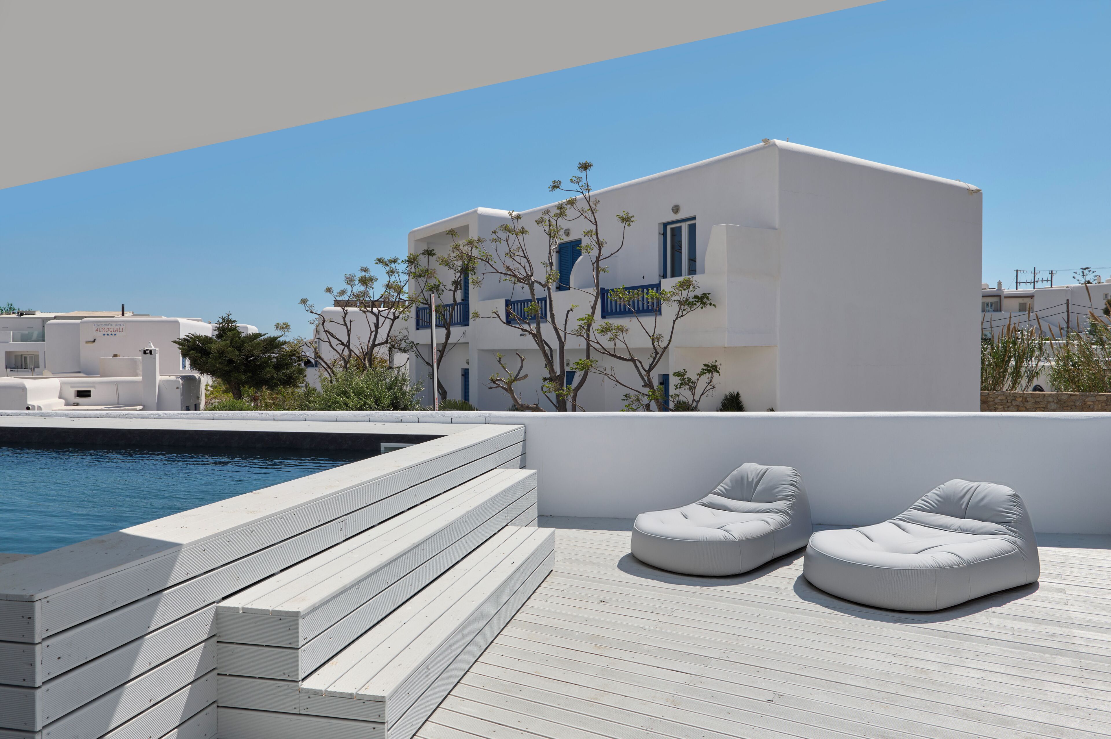 A modern building with a pool and outdoor seating.