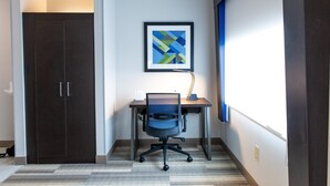 A room with a dark wooden wardrobe, a desk with a chair, and a framed abstract artwork on the wall. - Holiday Inn Express Columbus-Dublin by IHG (Dublin)