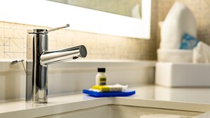 A modern bathroom with a chrome faucet, a soap dispenser, and a tissue box on the counter. - Holiday Inn Express Columbus-Dublin by IHG (Dublin)