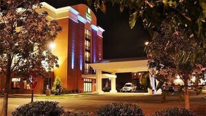 A hotel with a modern design, featuring a prominent entrance and a well-lit facade. - Holiday Inn Express Hotel & Suites Norfolk Airport by IHG (Norfolk)