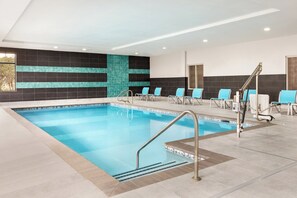 An indoor swimming pool with multiple lanes, a changing room area, and a seating area with chairs. - Holiday Inn Express Hotel & Suites Norfolk Airport by IHG (Norfolk)