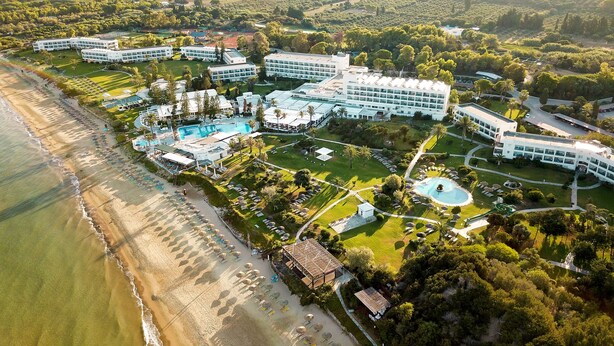 An aerial view of a resort with multiple buildings, a large pool, and a beach area. - ROBINSON KYLLINI BEACH (Andravida-Kyllini)