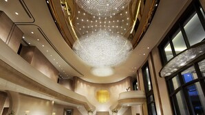 A spacious lobby with a grand chandelier, a marble floor, and a staircase leading to upper levels. - Harbour Grand Hong Kong (Hong Kong)