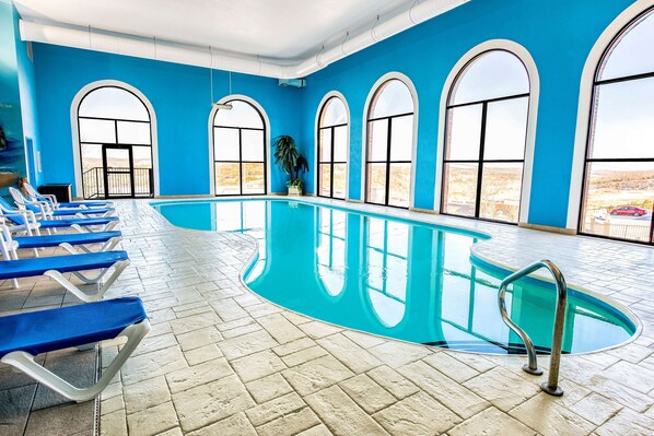 Indoor pool, open 10:00 AM to 10:00 PM, pool loungers