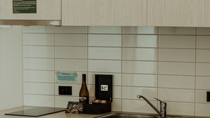 A modern kitchen with stainless steel appliances, a built-in oven, microwave, and dishwasher, and a sink with a faucet. - Quest Napier Serviced Apartment (Napier)