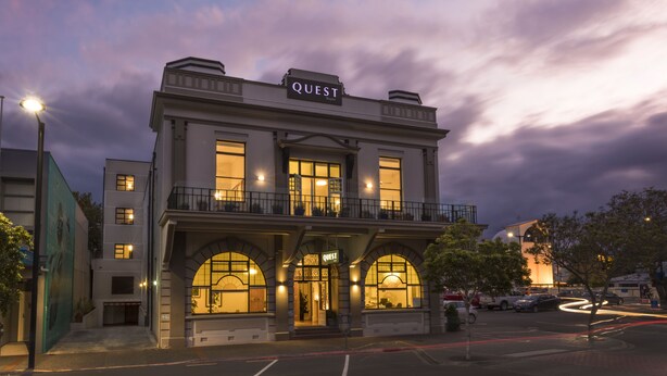 A building with a "QUEST" sign, featuring a classic architectural style with arched windows and a balcony. - Quest Napier Serviced Apartment (Napier)
