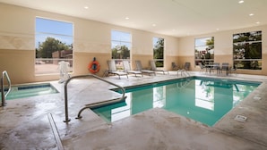 A swimming pool with clear water, surrounded by lounge chairs and a lifebuoy. - Best Western Coffeyville Central Business District Inn and Suites (Coffeyville)