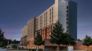 A multi-story hotel with a prominent sign for Hilton Garden Inn.