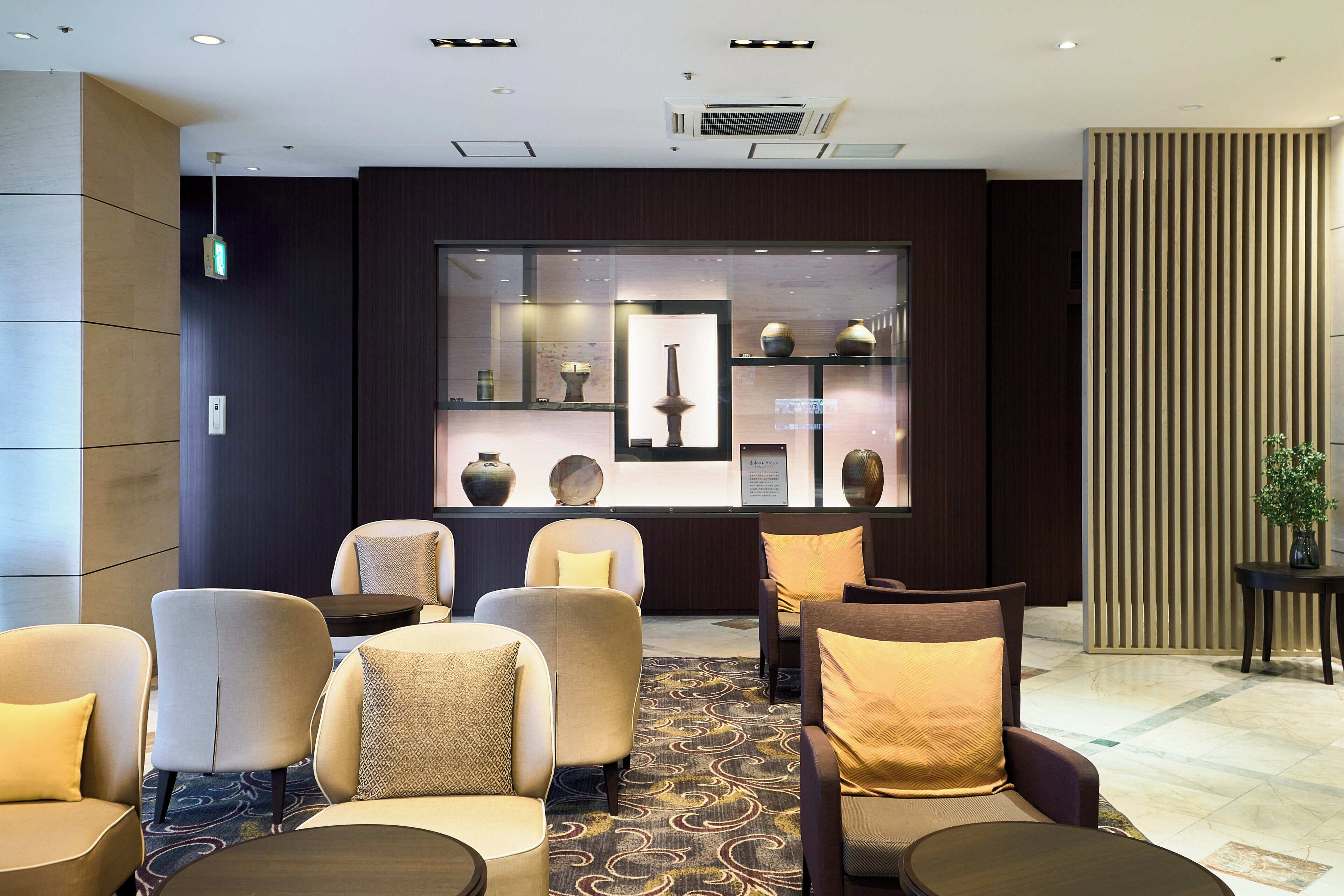 A lobby with seating, a reception desk, and a display of decorative items.
