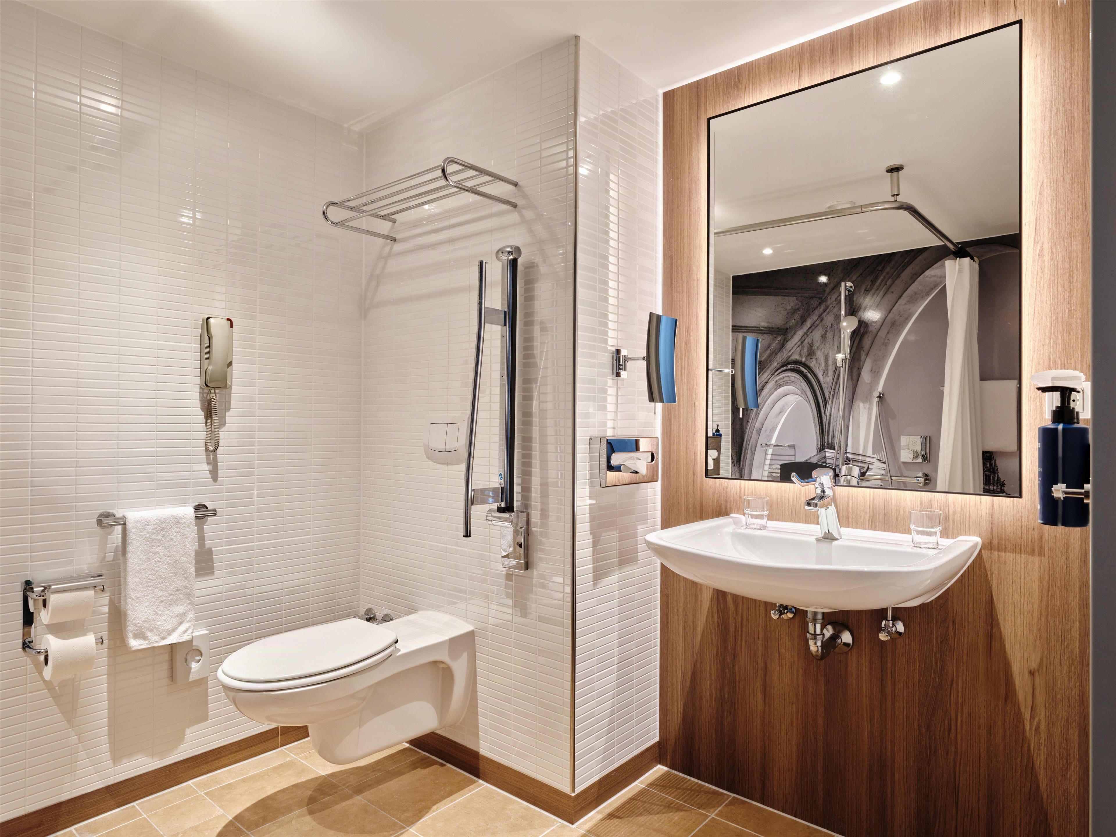 A modern bathroom with a toilet, bidet, and shower.