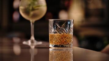 A bar setting with a clear glass and a wine glass.