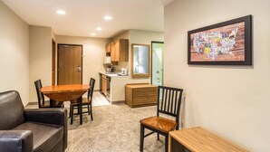 A compact living space with a dining area, kitchenette, and a bathroom.