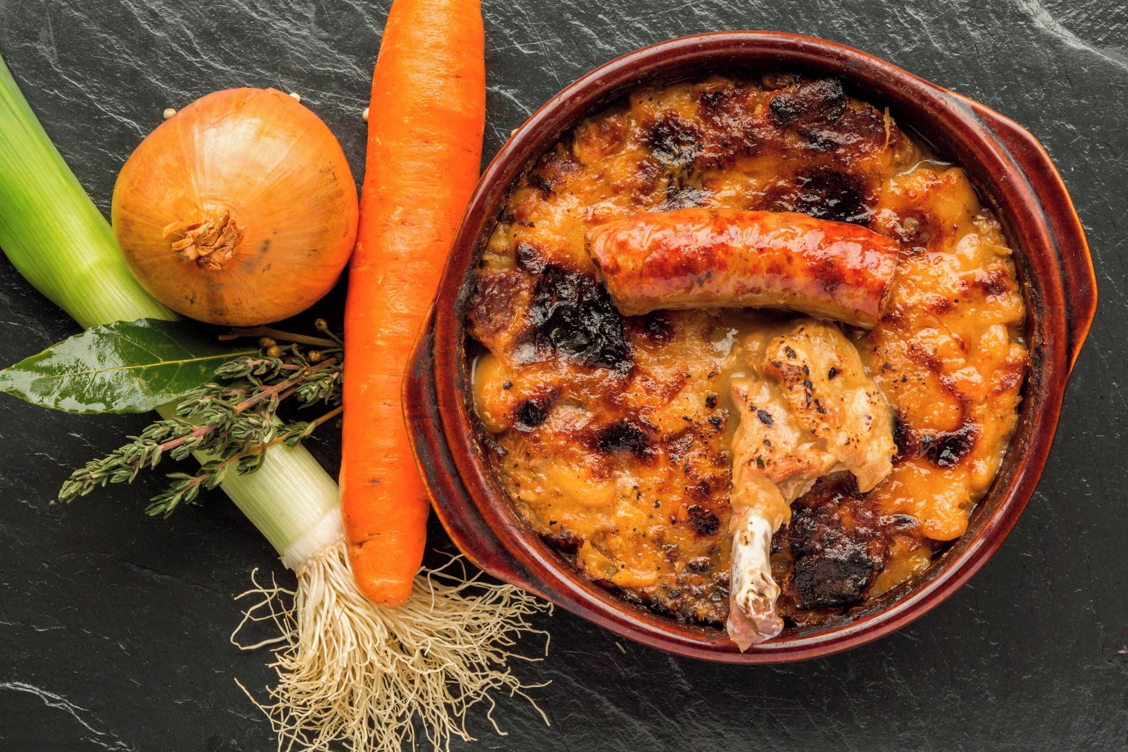 A dish with sausage and vegetables in a ceramic bowl.