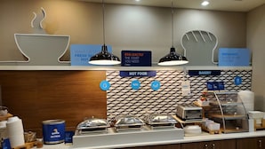 A breakfast buffet area with labeled stations for hot food, bakery, and grab & go options. - Holiday Inn Express Hotel and Suites Mankato East by IHG (Mankato)