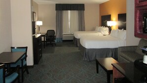 A hotel room with two beds, a desk, a chair, a table, and a TV. - Holiday Inn Express Hotel and Suites Fort Stockton by IHG (Fort Stockton)
