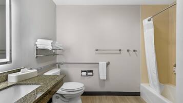 A modern bathroom with a toilet, sink, and shower.