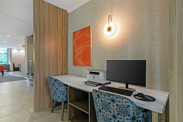 A modern office space with a desk, computer, and patterned chairs. - Holiday Inn Express & Suites Clemson by IHG (Clemson)