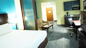 A hotel room with a bed, a sofa, a desk, a chair, a microwave, and a small kitchenette. - Holiday Inn Express Hotel & Suites Harrisburg West by IHG (Mechanicsburg)