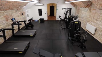 A gym with treadmills, stationary bikes, and weight machines.