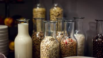 A variety of glass containers filled with different food items, likely in a kitchen or storage area.